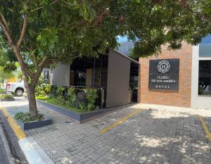 a building with a tree in front of it at Hotel Flores de Holambra in Holambra