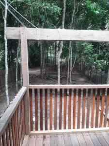 a wooden porch with a fence and trees at Alter Chale in Santarém