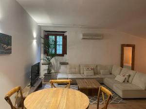a living room with a couch and a table at La Mer Hotel in Cabrera de Mar