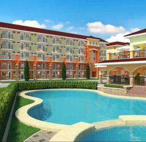 a large apartment building with a large swimming pool at 1 Bedroom Arezzo Condotel in Davao City +12 photos