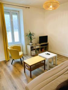a living room with a couch and a table at L'Ecrin Marin Centre historique Plage à 5 min in Le Croisic