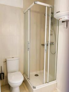 a bathroom with a toilet and a glass shower at L'Ecrin Marin Centre historique Plage à 5 min in Le Croisic +3 photos