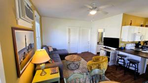 a living room with a kitchen and a living room with a table at The Monarch - 4 Butternut in Cherry Valley