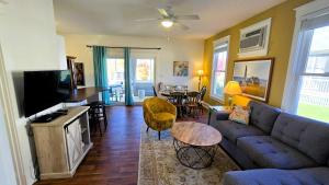 a living room with a blue couch and a tv at The Monarch - 4 Butternut in Cherry Valley