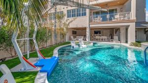 a swimming pool with a slide in a house at Sunset Lagoon Estate in Siesta Key