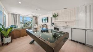 a kitchen with a large island in the middle at Sunset Lagoon Estate in Siesta Key +51 photos