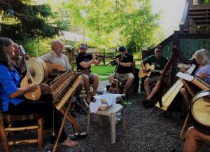 a group of people playing music and playing instruments at Laughing Horse Lodge in Bigfork +14 photos
