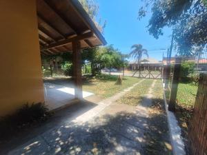 a porch of a house with a fence at Casa mami 800 mts do mar in Capão da Canoa