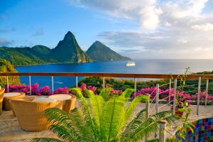 a balcony with a view of the ocean and mountains at Jade Mountain in Soufrière