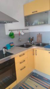 a kitchen with a sink and a stove at La Casa del Sole in Belvedere Ostrense