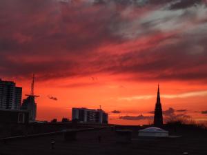a sunset over a city with a red sky at Midtown Geeste Appartement - Free Parking & WiFi in Bremerhaven
