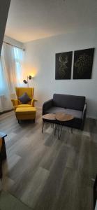 a living room with a couch and a table at Midtown Geeste Appartement - Free Parking & WiFi in Bremerhaven