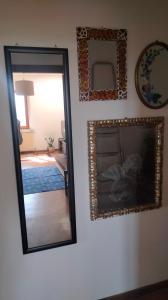 a mirror on a wall next to a bedroom at La Casa del Sole in Belvedere Ostrense