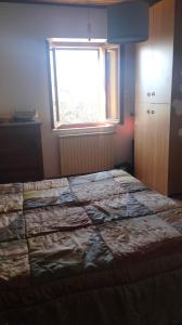 a bedroom with a large bed with a window at La Casa del Sole in Belvedere Ostrense +7 photos