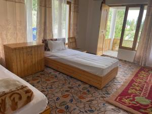 a bedroom with a large bed and a window at Baltipa Homestay in Pānāmik