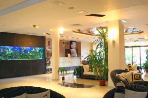 a lobby with couches and a fish tank in a store at Laguna Beach Resort & Spa in Sozopol