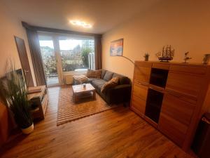 ein Wohnzimmer mit Couch und großem Fenster in der Unterkunft Lord Nelson Apartment 14 in Cuxhaven