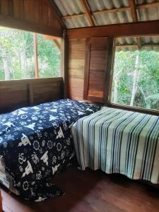 a bedroom with a bed in a cabin at Alter Chale in Santarém