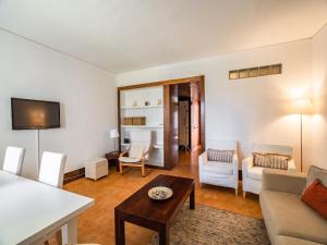 a living room with a couch and a table at Akisol Troia Apricot in Troia