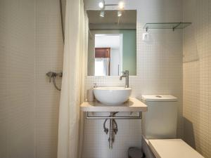 a bathroom with a sink and a toilet and a mirror at Akisol Troia Apricot in Troia +14 photos