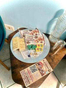 a table with a plate of food and a newspaper at Malpensa House 27 - Taxi service for MXP 25 Euro in Lonate Pozzolo