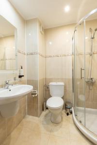 a bathroom with a toilet and a sink and a shower at Hotel Iceberg Bansko in Bansko
