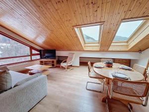 a living room with a table and some windows at Enchaple A5 in Saint-Jean-d'Aulps +5 photos