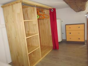 a wooden book shelf in a room with a dresser at Douillet F1 Place Paoli in Corte