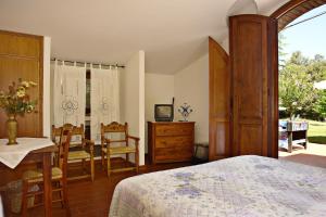 a bedroom with a bed and a table and chairs at La Cerretola in Città della Pieve +46 photos