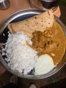 a bowl of food with rice and a tortilla at Primal Camping in Yelagiri