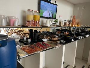 a buffet with many different types of food on a table at Pousada Maré Alta Pajuçara in Maceió