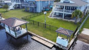 an aerial view of a house with a dock in the water at Dig'n It in West Onslow Beach