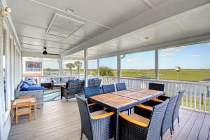 a porch with a table and chairs on a deck at Dig'n It in West Onslow Beach +70 photos