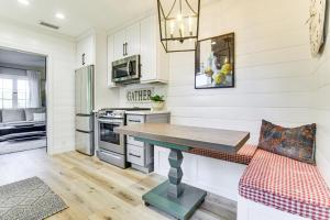 a kitchen with white walls and a table and a couch at Steps to Lake Arrowhead Village Chic Apartment in Lake Arrowhead +12 photos