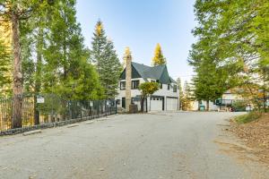 an empty driveway in front of a white house at Steps to Lake Arrowhead Village Chic Apartment in Lake Arrowhead