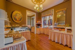 a bakery with tables filled with different types of food at Solar dos Poetas in Lisbon
