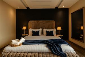 a bedroom with a large bed with a blue blanket at Montressa Executive Stay - Gold Crest Mall Phase 4 Lahore in Lahore