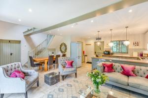 a living room with a couch and chairs and a table at Frith Farm House Cottages in Newnham