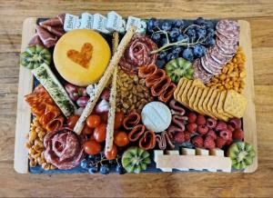 a tray filled with different types of food on a table at Domaine des Pins L'île au Dôme in Grundviller