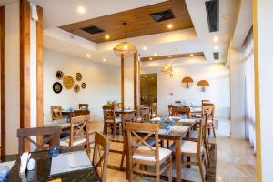 a dining room with wooden tables and chairs at AJIRA Bay Hotel Hurghada Marina in Hurghada +35 photos