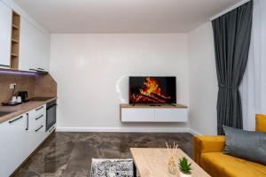 a living room with a fireplace in the wall at Apartmani Deluxe in Sanski most
