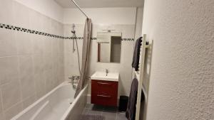 a bathroom with a tub and a sink and a shower at La vita è bella in Sélestat +15 photos