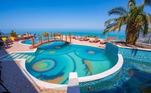 a swimming pool at a resort with a palm tree at Litz Resort in Kvariati +61 photos