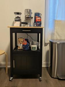 a black cart with a table with food on it at Private One Bedroom Apartment in Times Square & Central Park in New York +3 photos