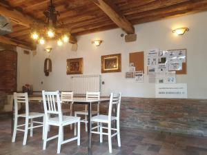 Vacation Home Tuscany Pisa-Lucca 0 في Filettole: غرفة طعام مع طاولة وكراسي بيضاء