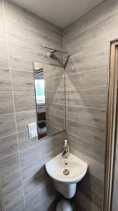 a bathroom with a white sink and a mirror at Dom Narciarza in Szczyrk +42 photos