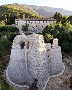 an old castle with a building in the background at Il Cantico in Cagli