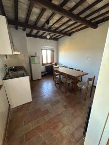 a kitchen and dining room with a table and refrigerator at Il Cantico in Cagli