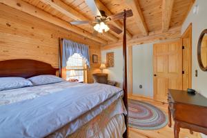 a bedroom with a bed and a ceiling fan at 1 Mi to Lake Tillery Outdoor Retreat with Hot Tub! in Badin +37 photos