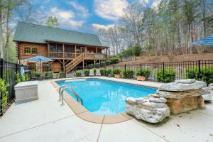 a swimming pool in front of a house at 1 Mi to Lake Tillery Outdoor Retreat with Hot Tub! in Badin